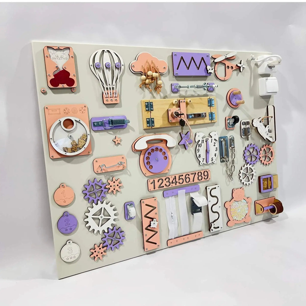 Children's educational board with various shaped and colored magnetic pieces on a white background