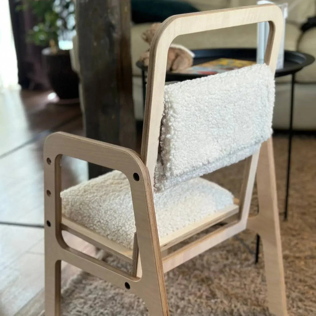 Wooden chair with white cushion in a room setting