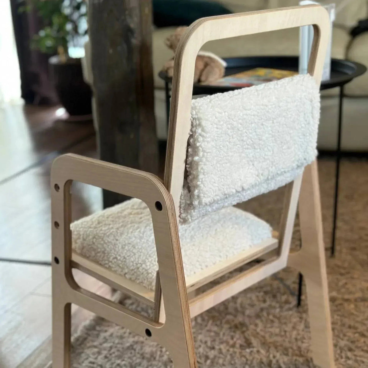 Wooden chair with white cushion in a room setting