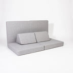 Gray upholstered bench with backrest on a white background