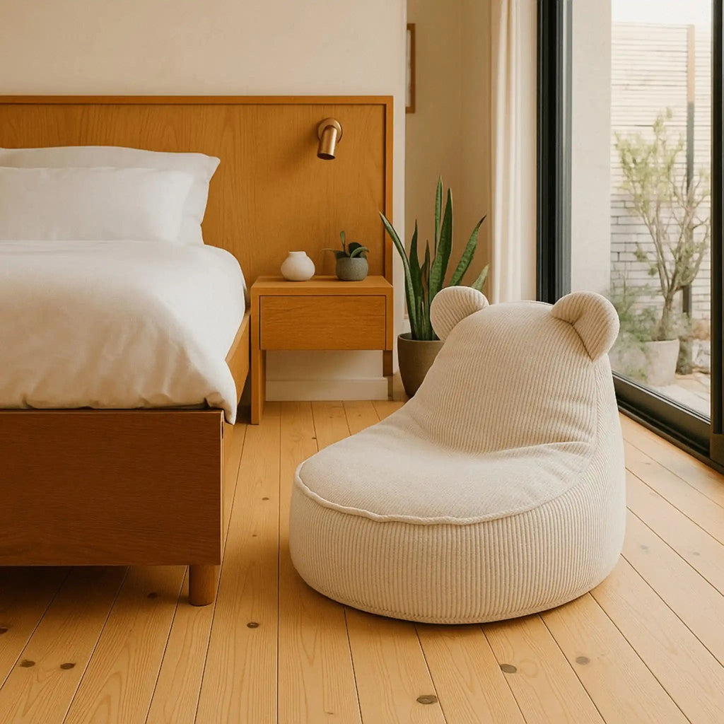 Beige bean bag chair in a bedroom with wooden bed and nightstand.