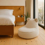 Beige bean bag chair in a bedroom with wooden bed and nightstand.