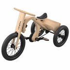 Children's tricycle with wooden frame and black seat on a white background