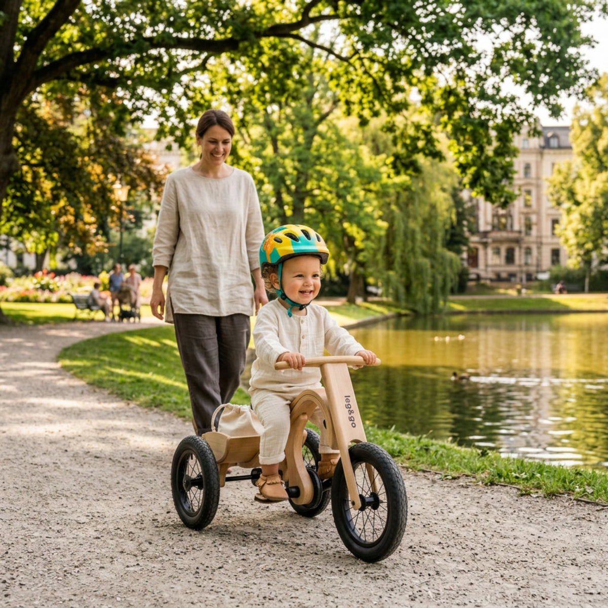 Children's tricycle with wooden frame and black seat on a white background